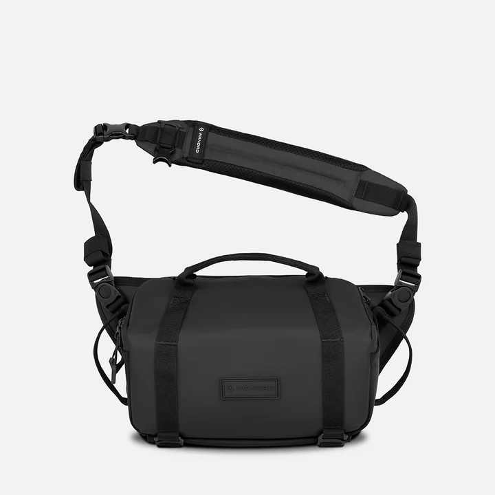 black shoulder bag with a visible brand logo on a white background