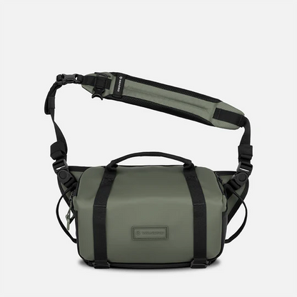 Green and black shoulder bag with a visible brand logo on a white background