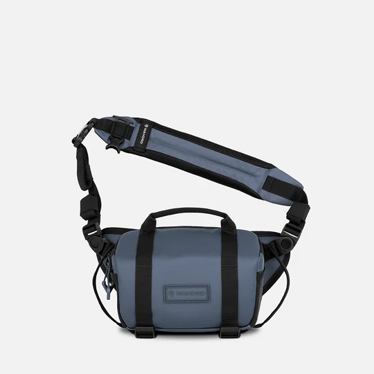 Blue shoulder bag with black straps on a white background