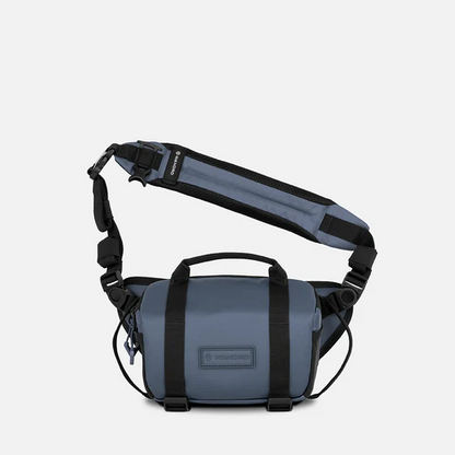 Blue shoulder bag with black straps on a white background