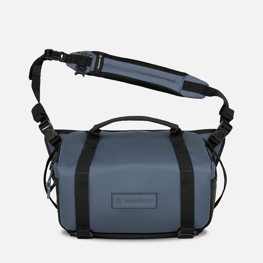 Blue bag with black straps on a white background