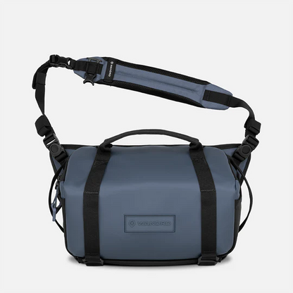 Blue bag with black straps on a white background