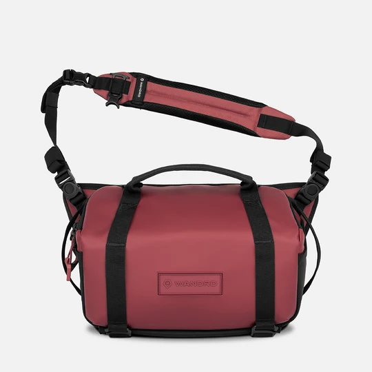 burgandy bag with black straps on a white background