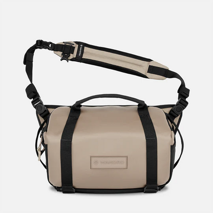 Beige and black bag with a strap on a white background