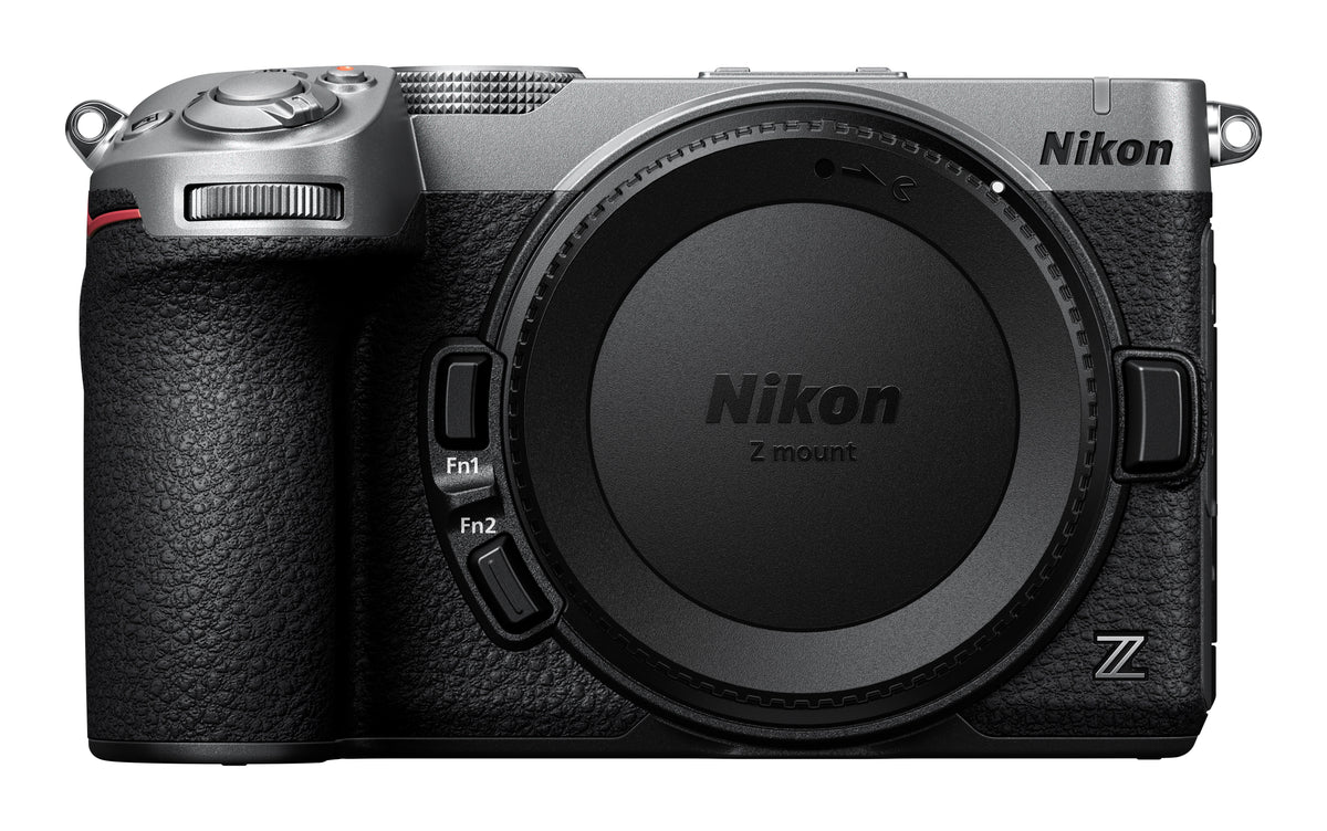 Nikon Z-mount mirrorless camera body in silver and black, shown from the front with the lens removed and Nikon branding visible on the top and lens cover.