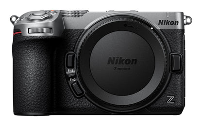 Nikon Z-mount mirrorless camera body in silver and black, shown from the front with the lens removed and Nikon branding visible on the top and lens cover.
